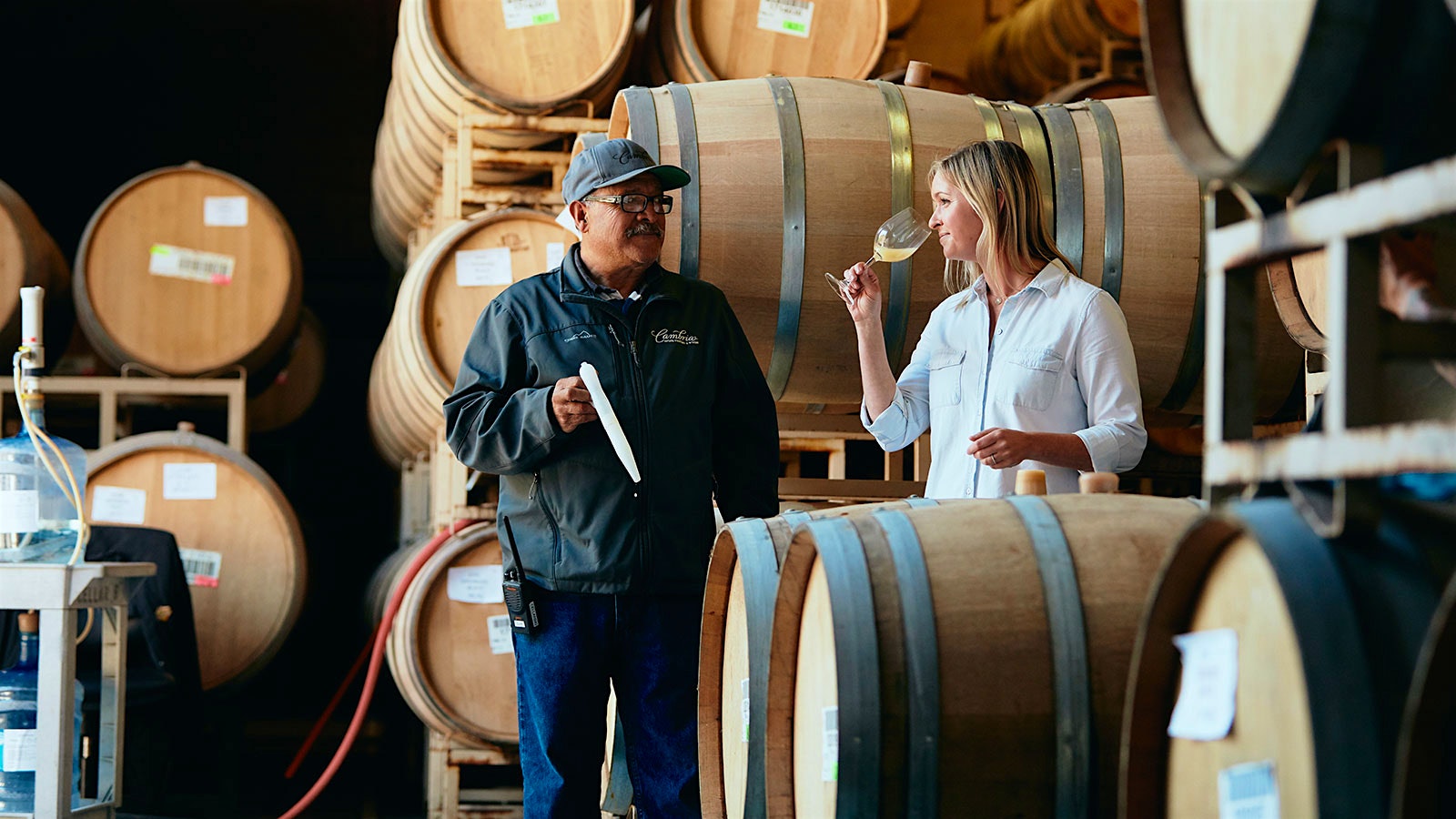 Winemaker Jill Russell trying a barrel sample with a co-worker
